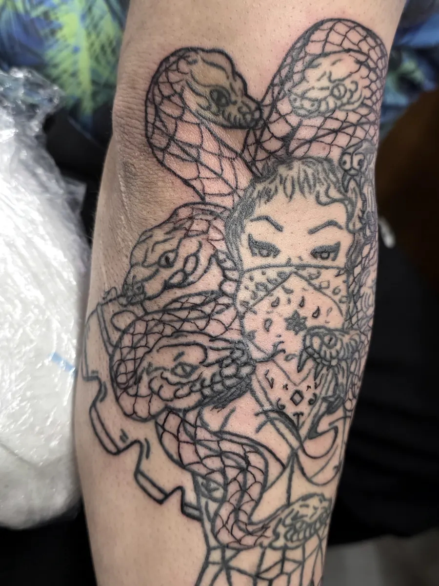 Close detail of linework from a large arm tattoo.
