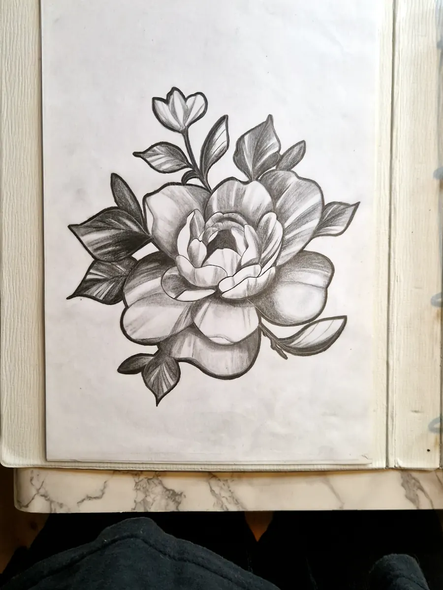 Flower tattoo design drawn on paper.