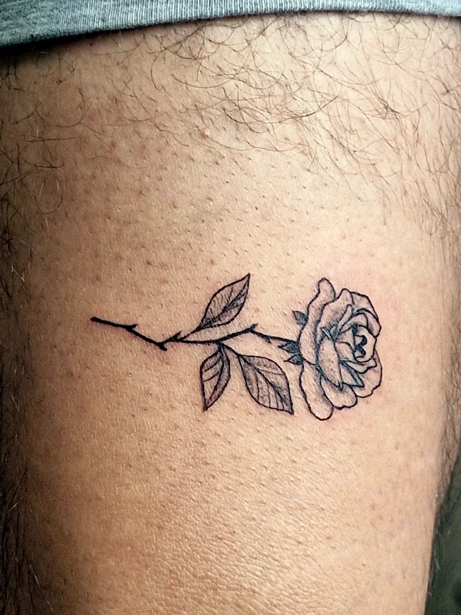Small rose tattoo on an arm.