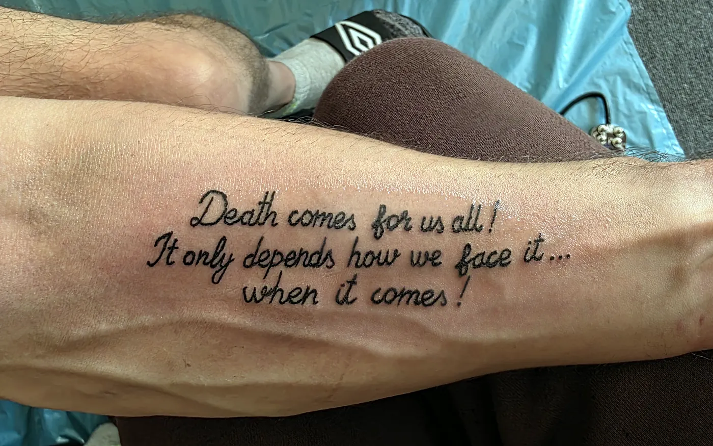 Script tattoo placed along a forearm.